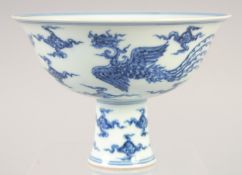 A CHINESE BLUE AND WHITE PORCELAIN STEM CUP with dragon and phoenix. 15.5cm diameter.