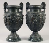 A VERY GOOD PAIR OF CLASSICAL SKIMMED BRONZE TWO HANDLED URNS with a band of classical figures, on a