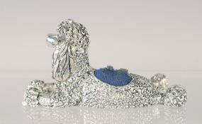 A SILVER PLATED POODLE PIN CUSHION.
