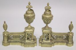 A GOOD PAIR OF 19TH CENTURY CAST BRASS CHENETS with urn finials. 1ft 3ins high, 11ins wide.