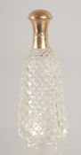 A CARVED CUT GLASS SCENT BOTTLE with 18ct gold top. 3.25ins.
