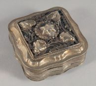 A DUTCH SILVER PILL BOX with embossed and engraved decoration. 5cm wide.