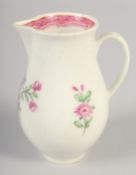 AN 18TH CENTURY WORCESTER JUG painted with flowers and an internal pink diaper border.