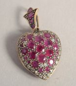 A 9CT GOLD RUBY AND DIAMOND HEART SHAPED LOCKET.