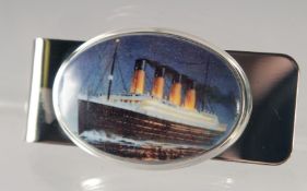 A SILVER AND ENAMEL PAPER CLIP 