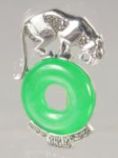 A SILVER AND JADE BROOCH.
