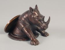 A CHINESE CIRCULAR BRONZE RHINO. 4ins.