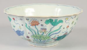 A CHINESE DOUCAI PORCELAIN PETAL FORM BOWL painted with fish and aquatic flora. 23xm diameter.