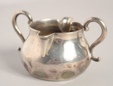 A SMALL GEORGE 1ST SAUCER-CREAM BOWL with two lips and two handles. 2.75ins diameter. London 1926.