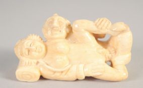A SMALL CARVED BONE EROTIC NETSUKE. 2ins.