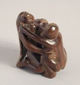 A CARVED WOOD EROTIC NETSUKE, signed. 1.5ins.