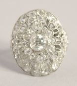 A SUPERB ART DECO PLATINUM AND DIAMOND OVAL PIERCED CLUSTER RING. 2.5cm x 2cm.