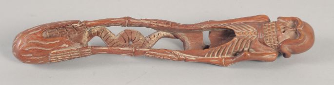 A LONG JAPANESE CARVED WOOD SKELETON. Signed. 8ins long.