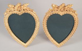 A PAIR OF GILT BRONZE HEART SHAPED PHOTOGRAPH FRAMES.