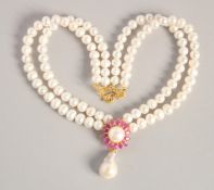 A PEARL NECKLACE with gold plated ruby and Baroque pearl clasp.