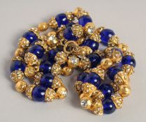 A CHANEL GILT METAL AND BLUE STONE NECKLACE, 16ins long, signed.