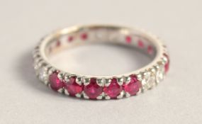 AN 18CT WHITE GOLD RUBY AND DIAMOND FULL ETERNITY RING.
