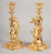 A GOOD PAIR OF GILT BRONZE CANDLESTICKS, the stems with classical figures, semi nude and man