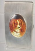A GOOD LARGE HEAVY ENGINE TURNED CIGARETTE CASE with and oval enamel of a King Charles Spaniel. 5.