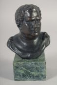 A SMALL BRONZE BUST OF A ROMAN on a marble base. 3.75ins high.