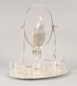 A GOOD SILVER PLATED AND GLASS LIQUEUR SET as a parrot on an oval base with six glasses. 15ins