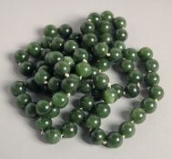A GOOD LONG JADE BEAD NECKLACE. 32ins long.