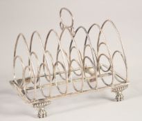 A GEORGE III SILVER SIX DIVISION TOAST RACK on four claw feet. London 1798. Maker: T. H. & G. H.