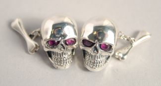 A PAIR OF SILVER SKULL CUFF LINKS.