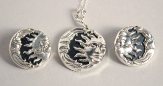 A SILVER AND ONYX CELESTIAL SUN AND MOON PENDANT AND EARRINGS.