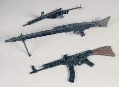 THREE MODEL 1/4 SCALE MACHINE GUNS, a Sten gun, an MG 42 and an AK 47, made of wood and metal, the