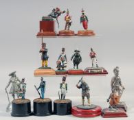 A COLLECTION OF FOURTEEN VARIOUS METAL SOLDIERS, on a stand, (14).