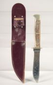 A PUMA NICKER SOLINGEN KNIFE, with antler handle in a leather sheath,7.5