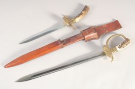 A HUNTING TROUSSEAU, mid-20th century, comprising sword with straight fullered 16in blade, brass