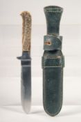A KNIFE, with antler handle in a sheath, 9