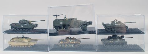 SIX VARIOUS DIECAST TANKS AND TRUCKS, in a Perspex case.