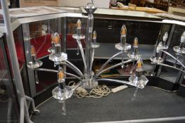 A stylish chrome plated and cut glass nine branch chandelier.