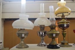 Four various oil lamps.