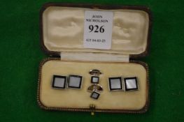 A cased pair of mother of pearl cufflinks with matching studs.