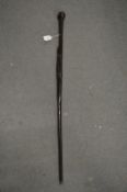 A carved wood walking stick.