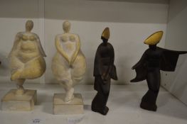 An unusual pair of small cast iron figures of Chinese ladies together with another pair of figures.