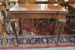 A good George III mahogany fold-over card table of shaped outline on carved cabriole legs with