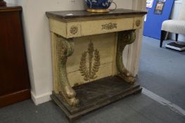 A decorative painted console table with a single drawer supported on dolphin columns.
