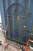 A wrought iron arch shaped gate 5' 5.5