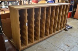 A modern oak sixty bottle wine rack.