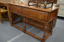 A walnut two drawer serving table.