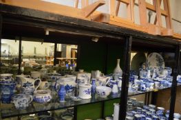 A large quantity of blue and white china to include egg cups, toast rack, mantel clock etc.