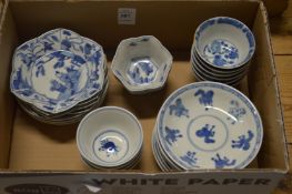 A collection of Chinese blue and white tea bowls and saucers.