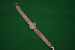 A Ladies 9 carat gold Omega wristwatch with 9 carat gold strap.