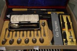 A cased silver spoon and other flatware.