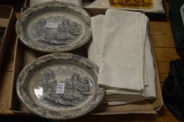 A pair of pottery dishes and various linen.